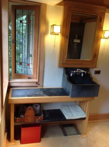 Single Soapstone Sink offset to the right on this craftsman style, open storage base cabinet.