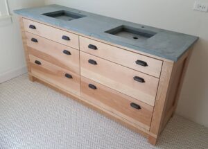 This double trough sink base cabinet is made of Birch wood. It has six spacious drawers for storage.