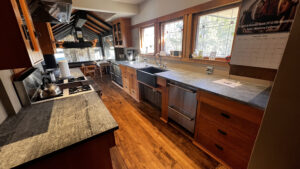 This image shows a complete view of the sink side of the Birch cabinets in this kitchen. 