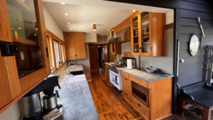 This image shows the complete run of cabinets on the range side of the kitchen. On the left side of the image you can see the upper cabinets on the sink side. The image also shows the original upper cabinet on the far end wall. This cabinet was built during the home's construction. Glen Ellyn Hilltop Gallery