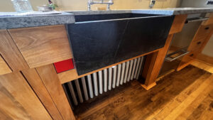 This image shows a another angle on the close up around the sink where there is a removable front to access the radiator beneath the sink. Glen Ellyn Hilltop Gallery