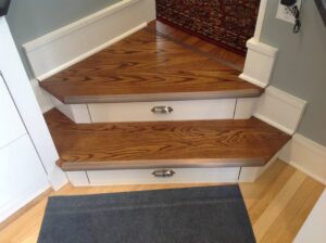 This image shows closed drawers in a set of stairs in a kitchen.