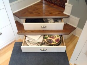 This image shows open drawers in a set of stairs in a kitchen.