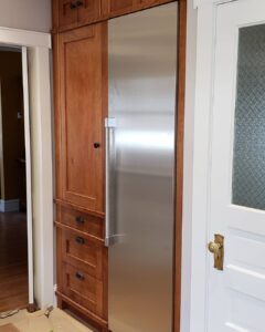 This image shows the pantry cabinet around the fridge. The Fridge seamlessly blends in with the cabinets.