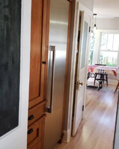 This image shows another angle of the pantry cabinet around the fridge. The Fridge seamlessly blends in with the cabinets.