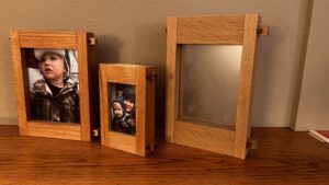 This image shows all Three Picture Frame sizes we offer. with the small, Medium and Large on a table top surface.